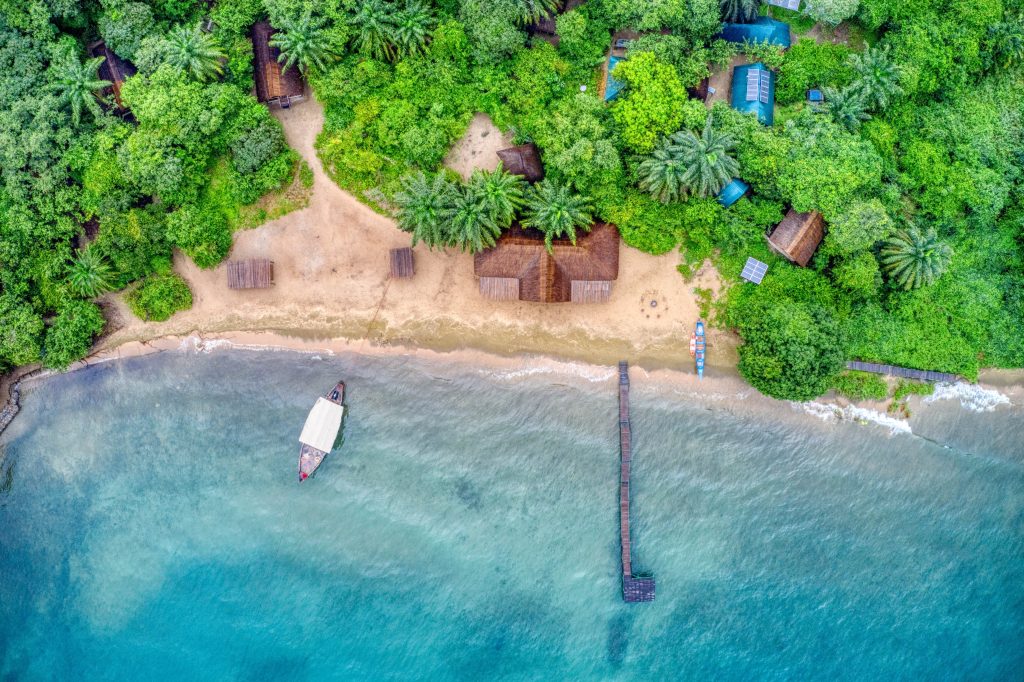 Aerial view of thatched bandas and jetty, Mahale Mountains National Park, Tanzania