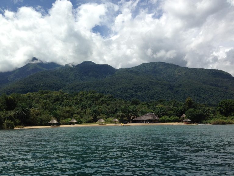 Forested peaks above thatched beach camp, Mahale Mountains National Park, Tanzania