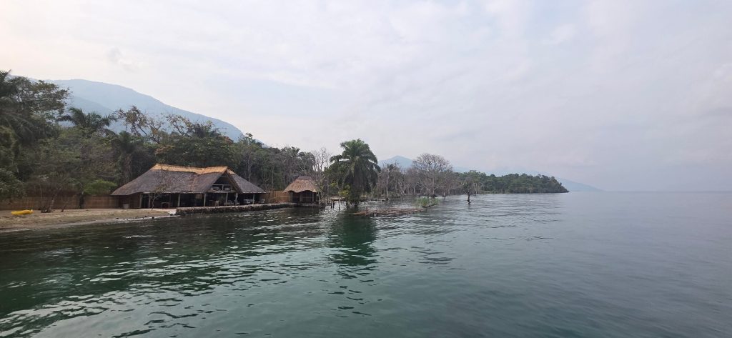 Panorama lodge and jetty on hazy shoreline, Mahale Mountains National Park, Tanzania