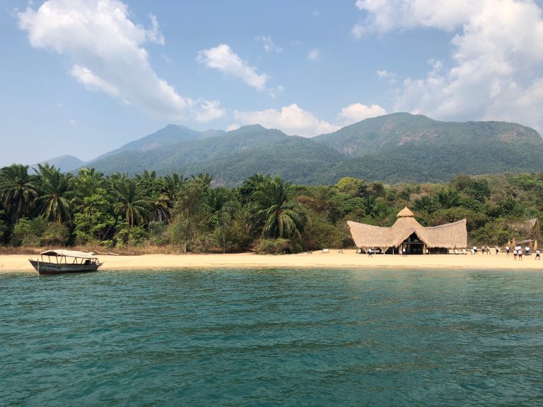 Thatched dining banda seen from the lake, Mahale Mountains National Park, Tanzania