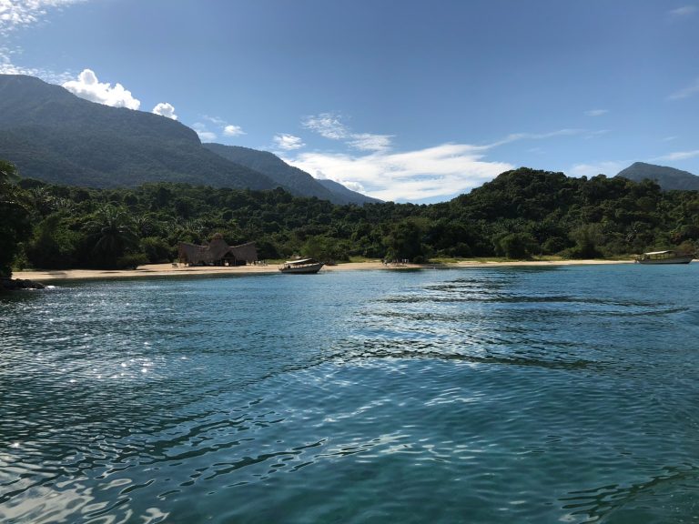 Turquoise lake approach to thatched beach camp, Mahale Mountains National Park, Tanzania